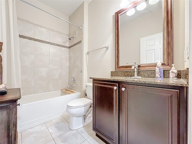 bathroom with vanity, shower / bath combination, tile patterned flooring, and toilet