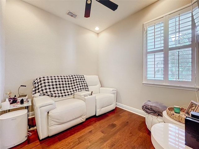 living area featuring baseboards, visible vents, ceiling fan, wood finished floors, and recessed lighting