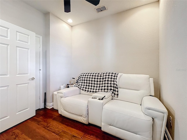 sitting room with dark wood-style floors, ceiling fan, and visible vents