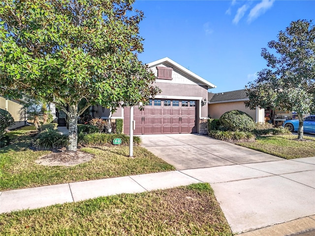 view of property hidden behind natural elements with a garage, driveway, a front yard, and stucco siding