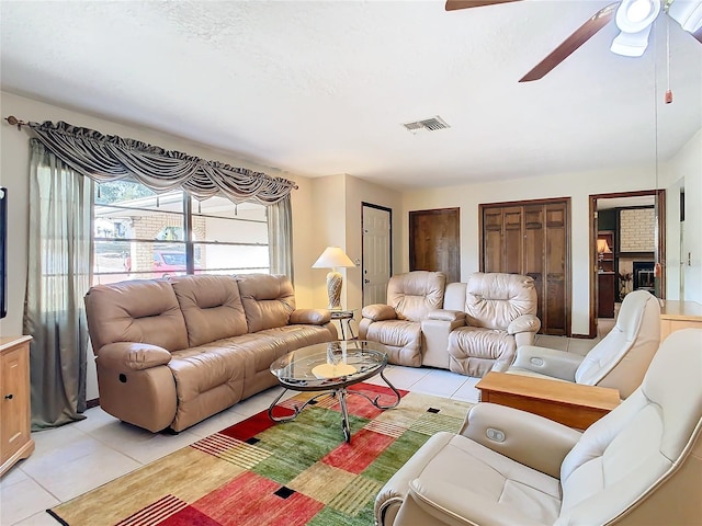 living room with light tile patterned floors and ceiling fan