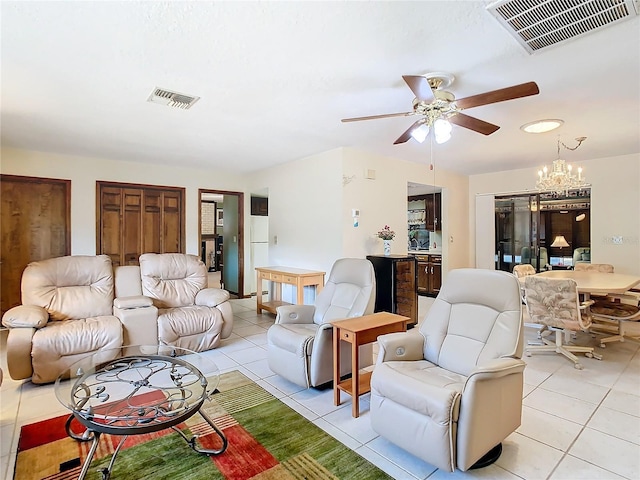 tiled living room featuring ceiling fan with notable chandelier