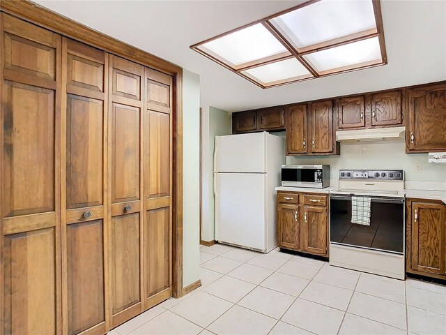 kitchen with light tile patterned floors and white appliances