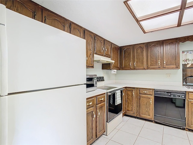 kitchen with light tile patterned flooring and white appliances