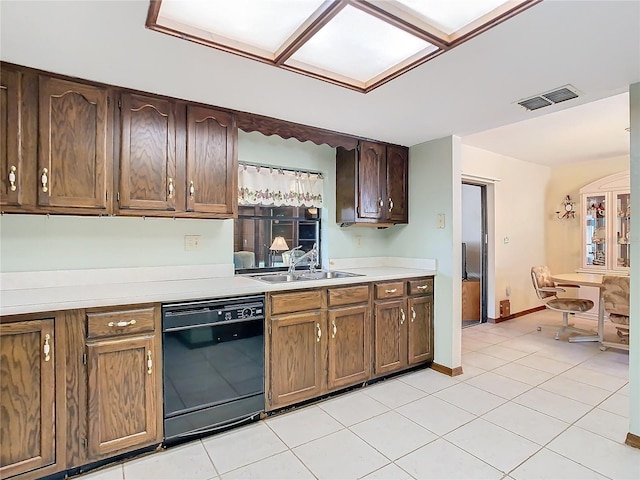 kitchen with sink, light tile patterned floors, and dishwasher