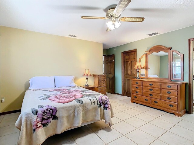 tiled bedroom featuring ceiling fan