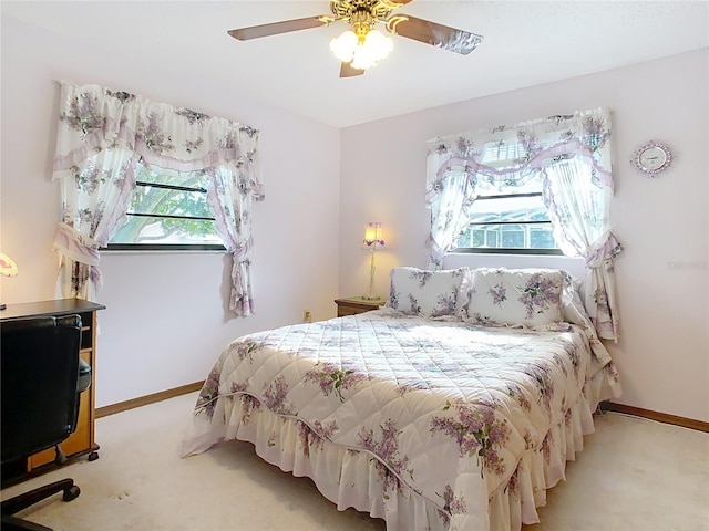 bedroom with light colored carpet and ceiling fan