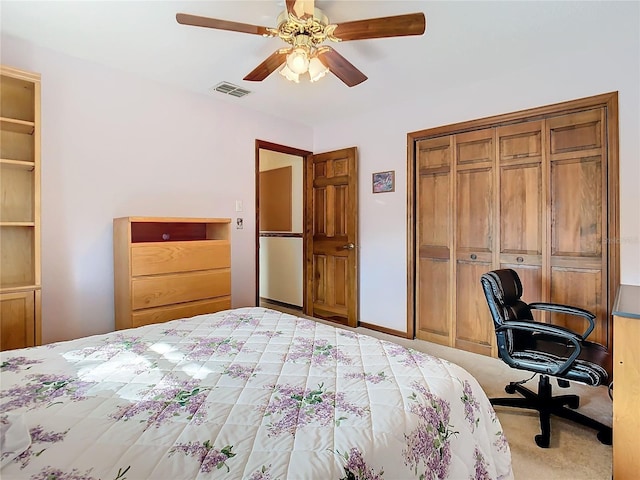 carpeted bedroom featuring a closet and ceiling fan