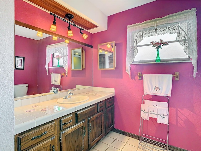 bathroom with tile patterned floors, vanity, and toilet