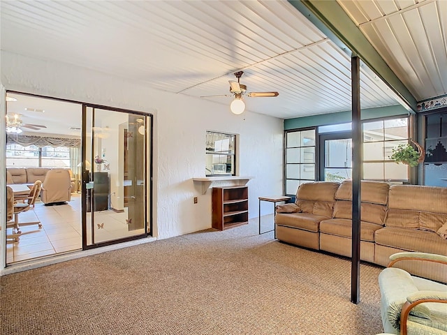 carpeted living room with ceiling fan