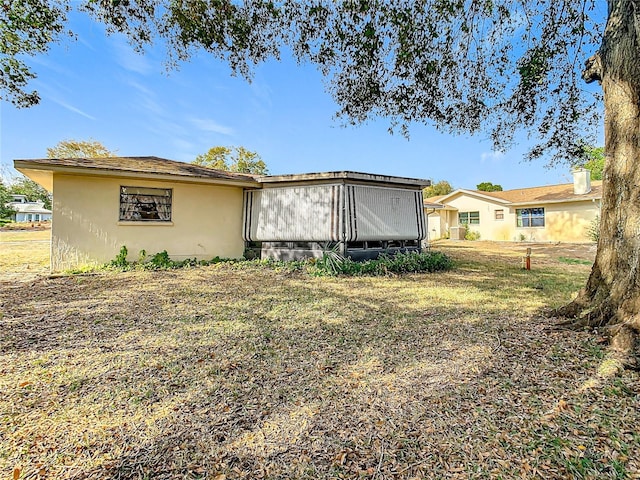 back of house featuring a lawn