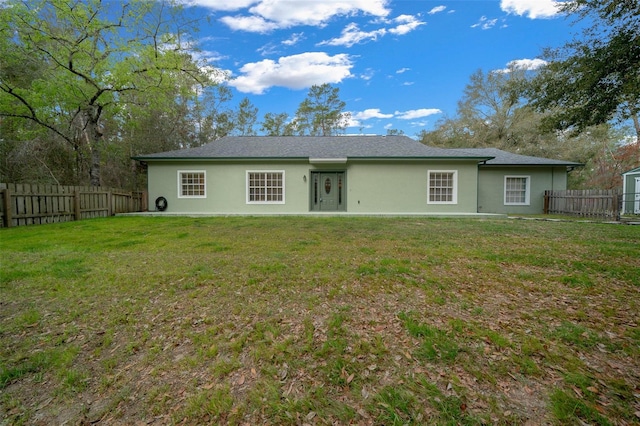 back of property with a lawn