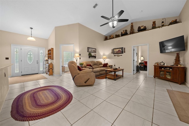 tiled living room with ceiling fan and high vaulted ceiling