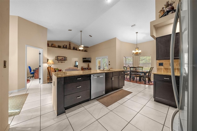 kitchen with dark brown cabinetry, sink, a center island, appliances with stainless steel finishes, and pendant lighting