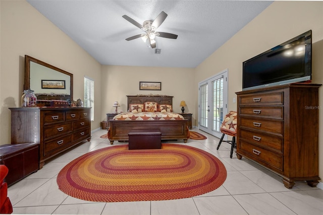 bedroom featuring light tile patterned flooring, ceiling fan, a textured ceiling, and access to outside