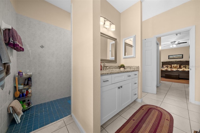 bathroom with ceiling fan, tile patterned floors, vanity, and a shower