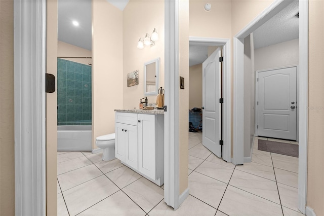 full bathroom featuring tiled shower / bath combo, vanity, tile patterned floors, and toilet