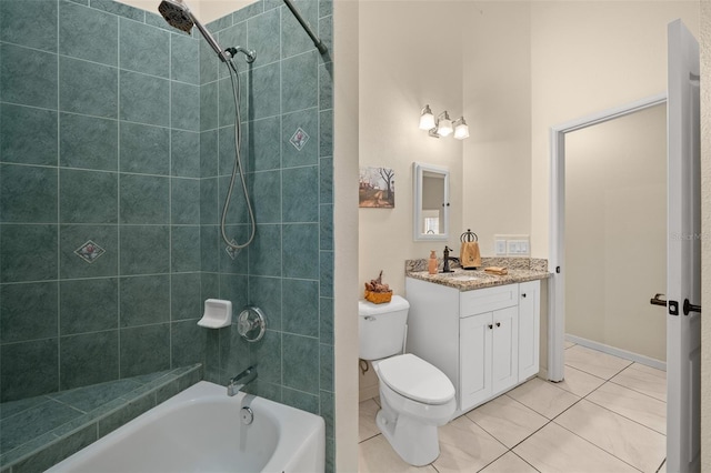 full bathroom featuring vanity, tile patterned floors, toilet, and tiled shower / bath