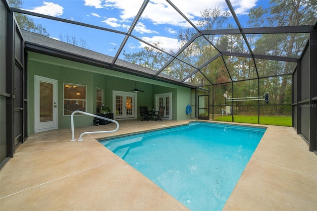 view of pool with a patio, a lanai, ceiling fan, and french doors