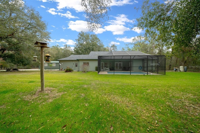 back of house featuring a lanai and a lawn