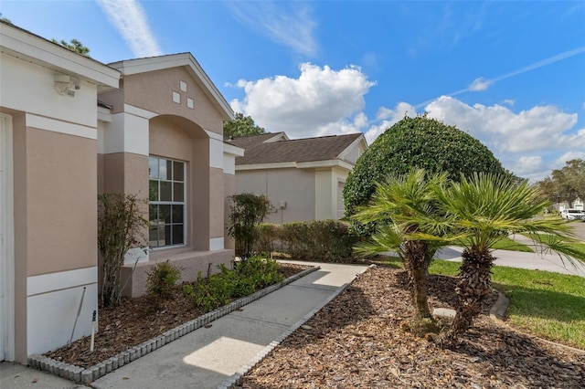 view of side of property featuring stucco siding