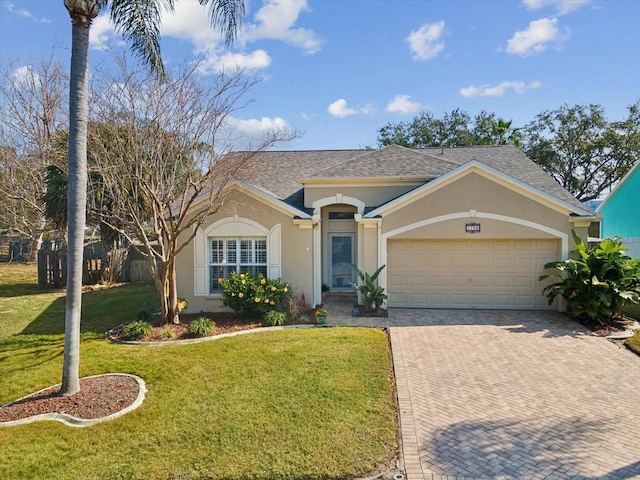 ranch-style home featuring a garage and a front lawn