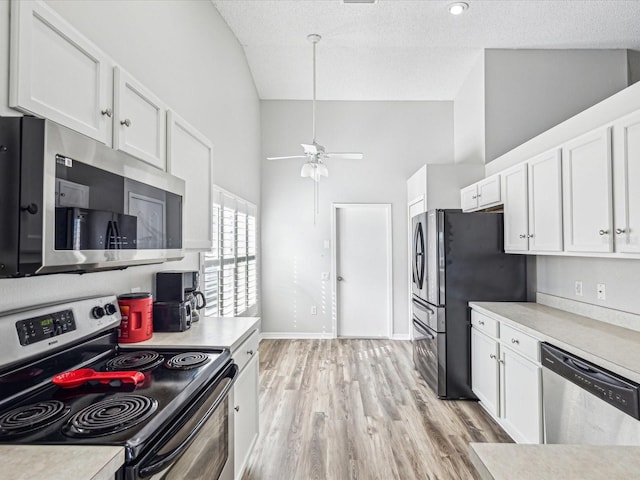 kitchen featuring a textured ceiling, light hardwood / wood-style flooring, stainless steel appliances, and white cabinets