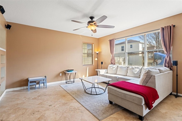 living room featuring plenty of natural light and ceiling fan