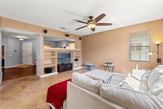 living room featuring built in features and ceiling fan