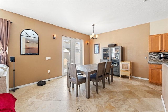 dining room with an inviting chandelier and french doors