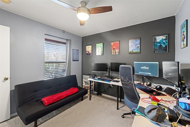 office area featuring light carpet and ceiling fan