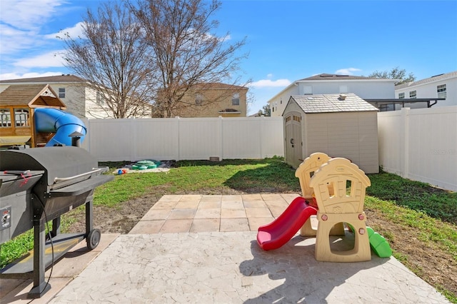 exterior space featuring area for grilling, a storage shed, and a playground