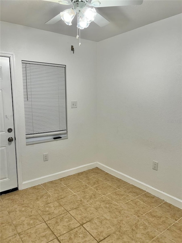 unfurnished room with ceiling fan and light tile patterned floors