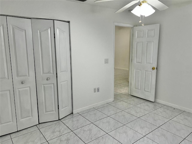 unfurnished bedroom featuring light tile patterned floors, ceiling fan, and a closet