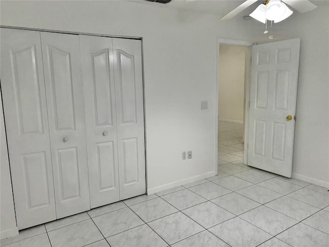 unfurnished bedroom featuring light tile patterned floors, a closet, and ceiling fan