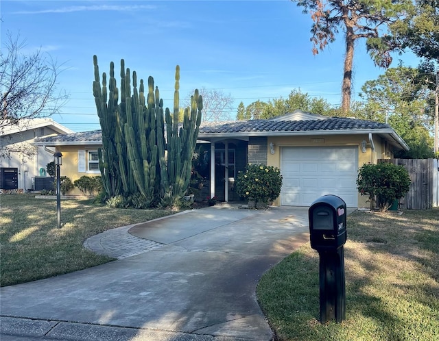 single story home with a garage, a front yard, and central AC unit