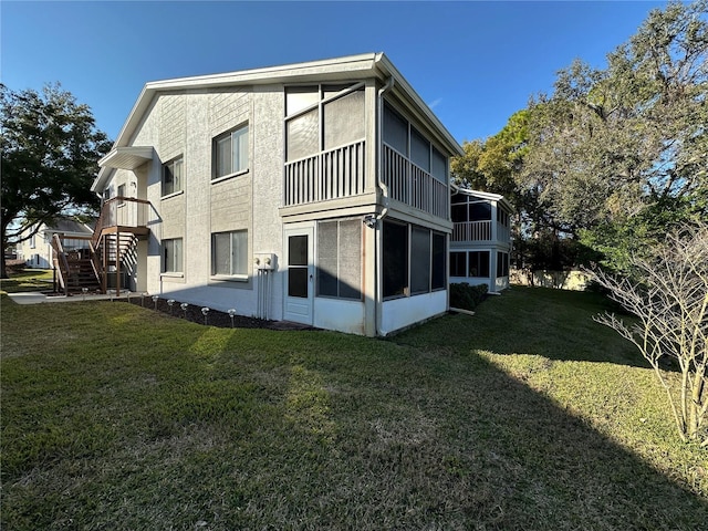 view of side of property with a yard and a sunroom