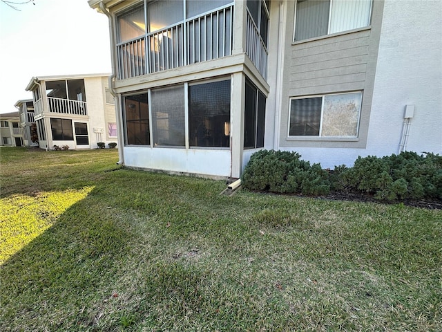 rear view of property featuring a yard