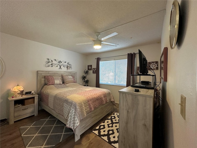 bedroom featuring ceiling fan, a textured ceiling, and dark hardwood / wood-style flooring