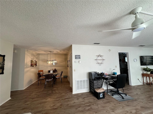 office space featuring ceiling fan, dark hardwood / wood-style flooring, and a textured ceiling