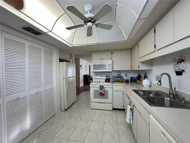 kitchen with sink, light tile patterned floors, ceiling fan, white appliances, and white cabinets