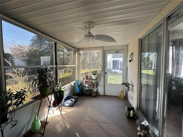 unfurnished sunroom featuring ceiling fan