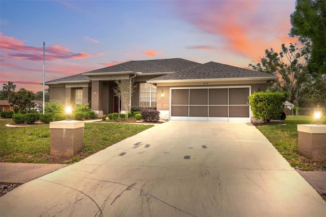 6112 Kinlock Ave, Spring Hill, FL 34608 - view of front of property featuring an attached garage, a front lawn, driveway, and stucco siding