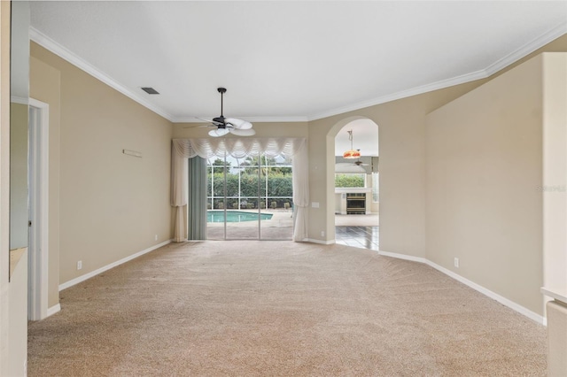 6112 Kinlock Ave, Spring Hill, FL 34608 - carpeted spare room with ceiling fan, plenty of natural light, ornamental molding, baseboards, and arched walkways