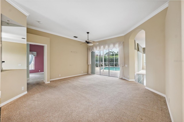 6112 Kinlock Ave, Spring Hill, FL 34608 - carpeted empty room featuring a ceiling fan, crown molding, arched walkways, and baseboards