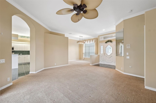 6112 Kinlock Ave, Spring Hill, FL 34608 - unfurnished living room featuring carpet, a ceiling fan, crown molding, arched walkways, and baseboards