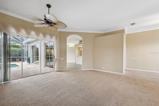 6112 Kinlock Ave, Spring Hill, FL 34608 - unfurnished room featuring ornamental molding, carpet floors, a ceiling fan, baseboards, and arched walkways