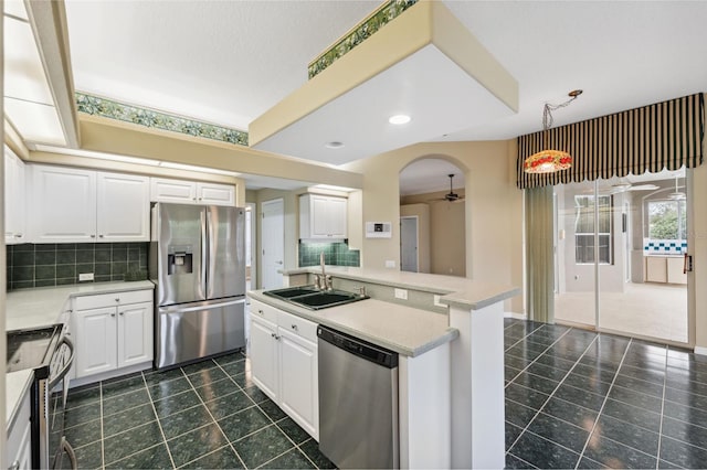 6112 Kinlock Ave, Spring Hill, FL 34608 - kitchen with appliances with stainless steel finishes, a sink, a ceiling fan, decorative backsplash, and recessed lighting
