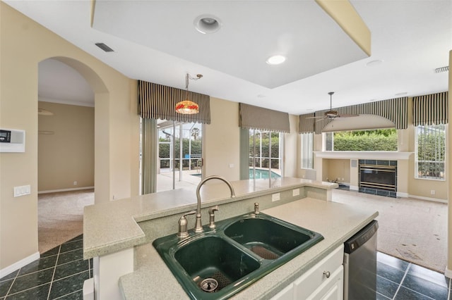 6112 Kinlock Ave, Spring Hill, FL 34608 - kitchen featuring a sink, stainless steel dishwasher, a ceiling fan, open floor plan, and a fireplace
