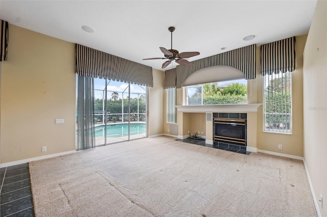 6112 Kinlock Ave, Spring Hill, FL 34608 - unfurnished living room with a ceiling fan, a tile fireplace, and carpet